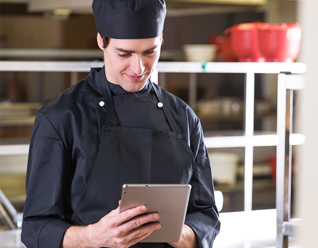 chef checking order on restaurant management system